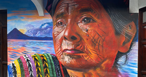 beautiful colorful Mayan street art of an old indigenous woman in front of Lake Atitlan, Guatemala
